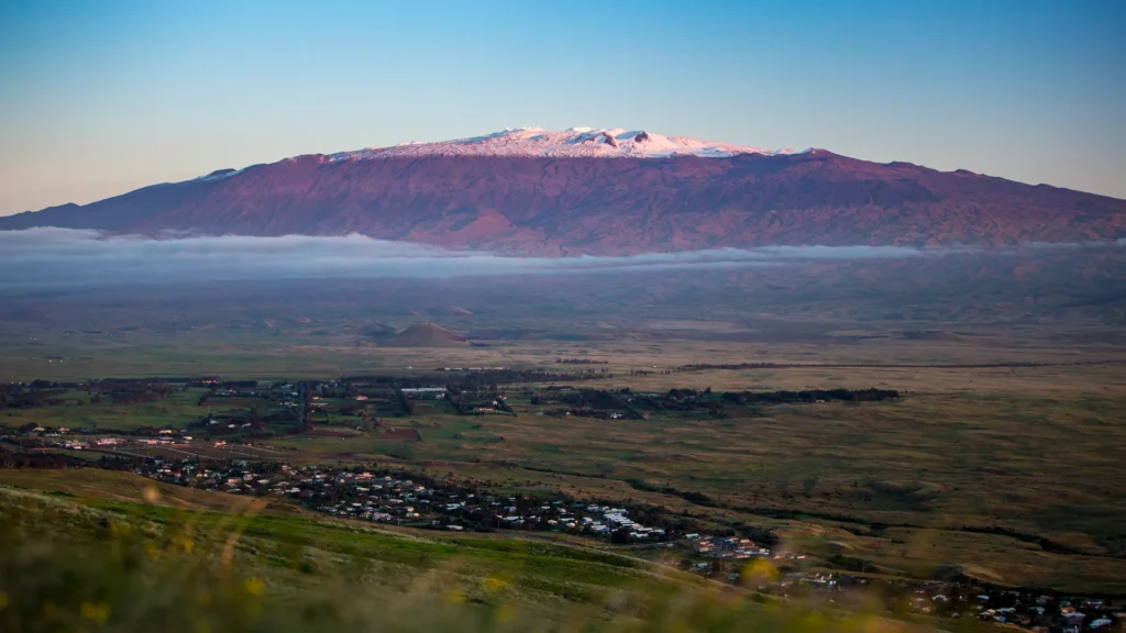 wide angle tilt shift photograph of a snow capped mauna kea mountain on the big island of hawaii